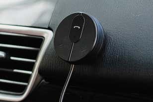 The Besign BK01 Bluetooth Car Kit shown mounted on a car dash.