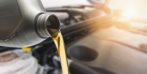 close up of oil pouring in car
